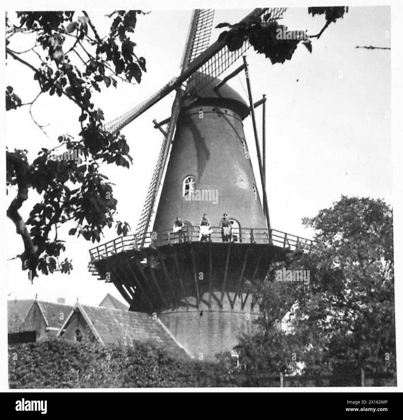 I soldati Arthur Bullock, George Fitton, Harry Smith e il sergente William Mason appendono il bucato fuori da un mulino a vento olandese durante il servizio dell'esercito britannico, del 21st Army Group. Foto Stock