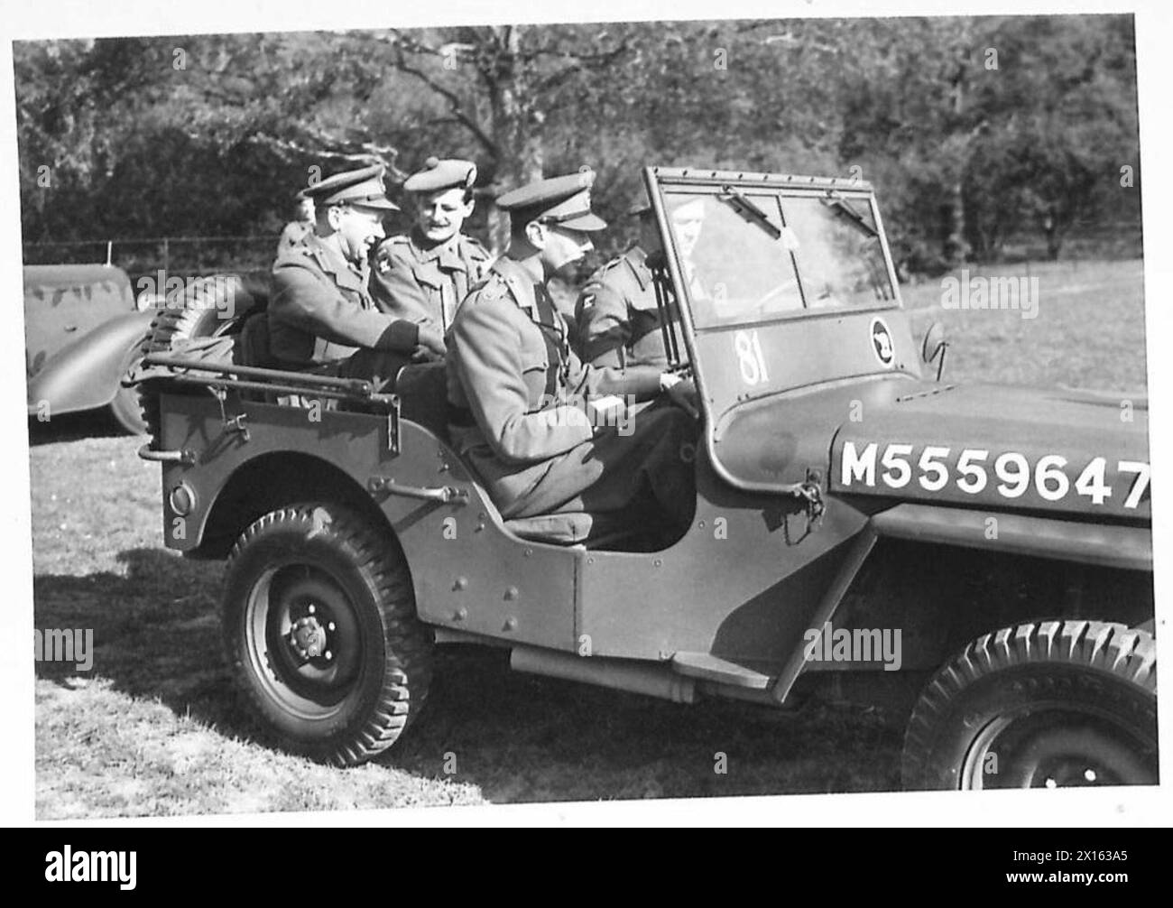 Sua Maestà il Re viene fotografato mentre cavalca una Jeep mentre ispeziona le truppe d'invasione. Foto Stock