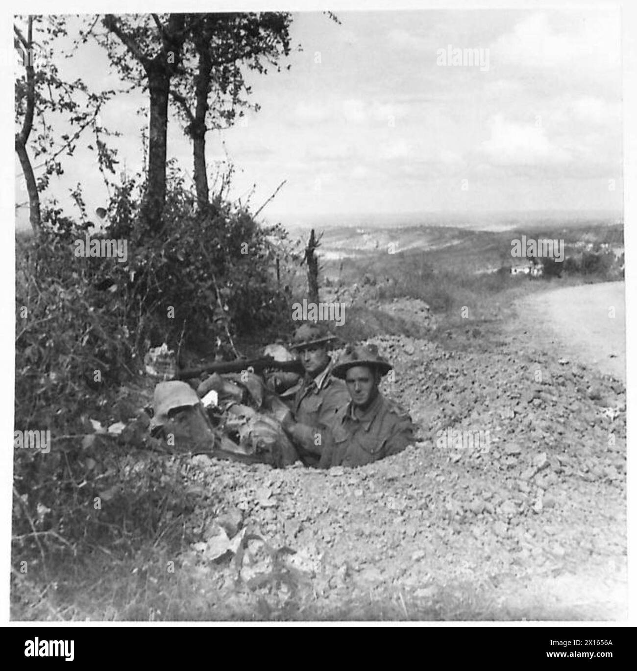 I fanti dell'Ottava Armata sono scavati sul ciglio della strada che domina il fiume Marano e la valle durante le operazioni in Italia. Foto Stock