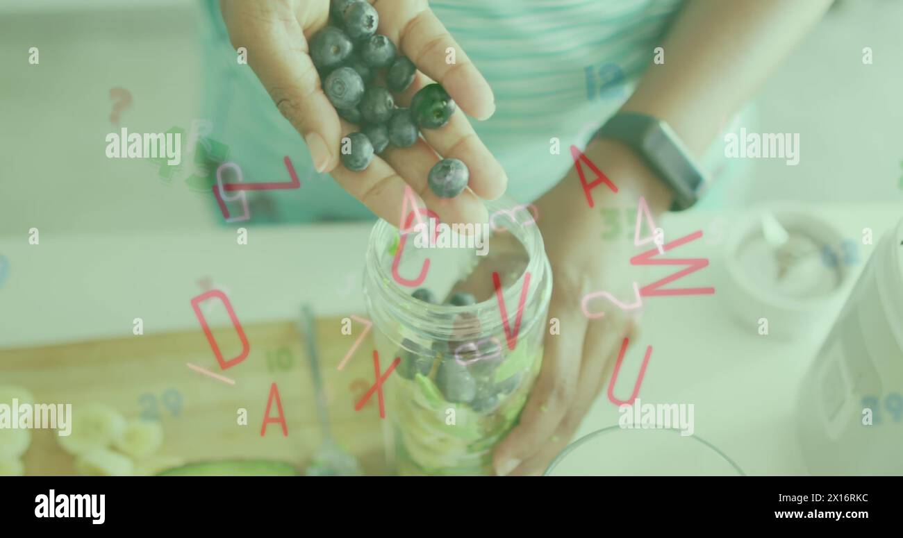 Immagine di lettere e numeri che cadono sopra una donna caucasica che prepara la colazione con le bacche Foto Stock