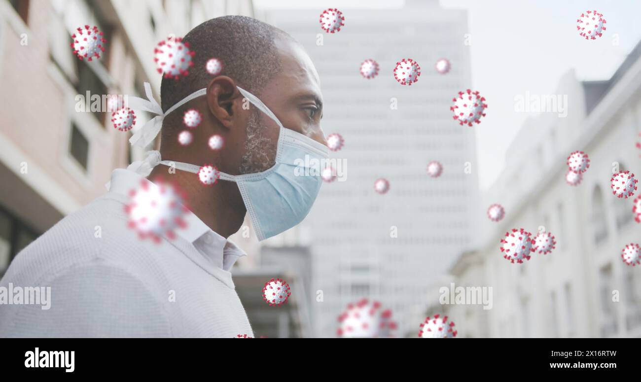 Immagine di cellule covid 19 sopra l'uomo afroamericano che indossa la maschera facciale Foto Stock