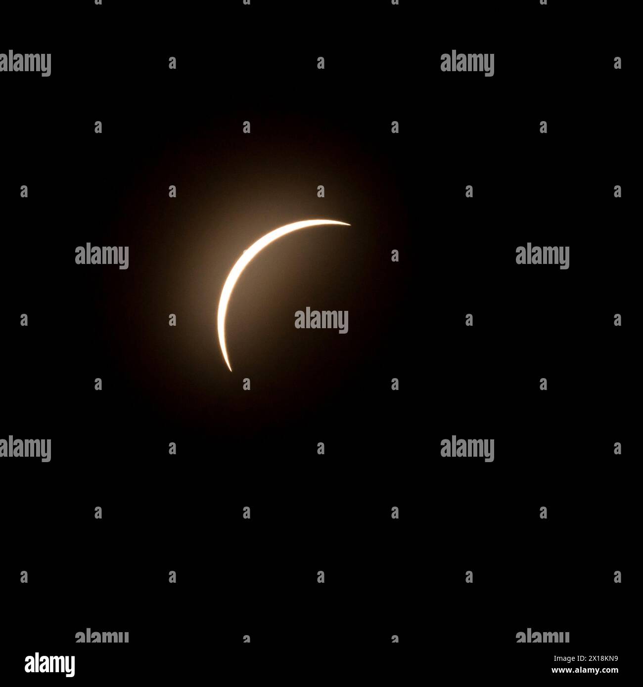 Fase finale dell'eclissi solare nell'aprile 2024 con la luna che inizia a coprire il sole Foto Stock