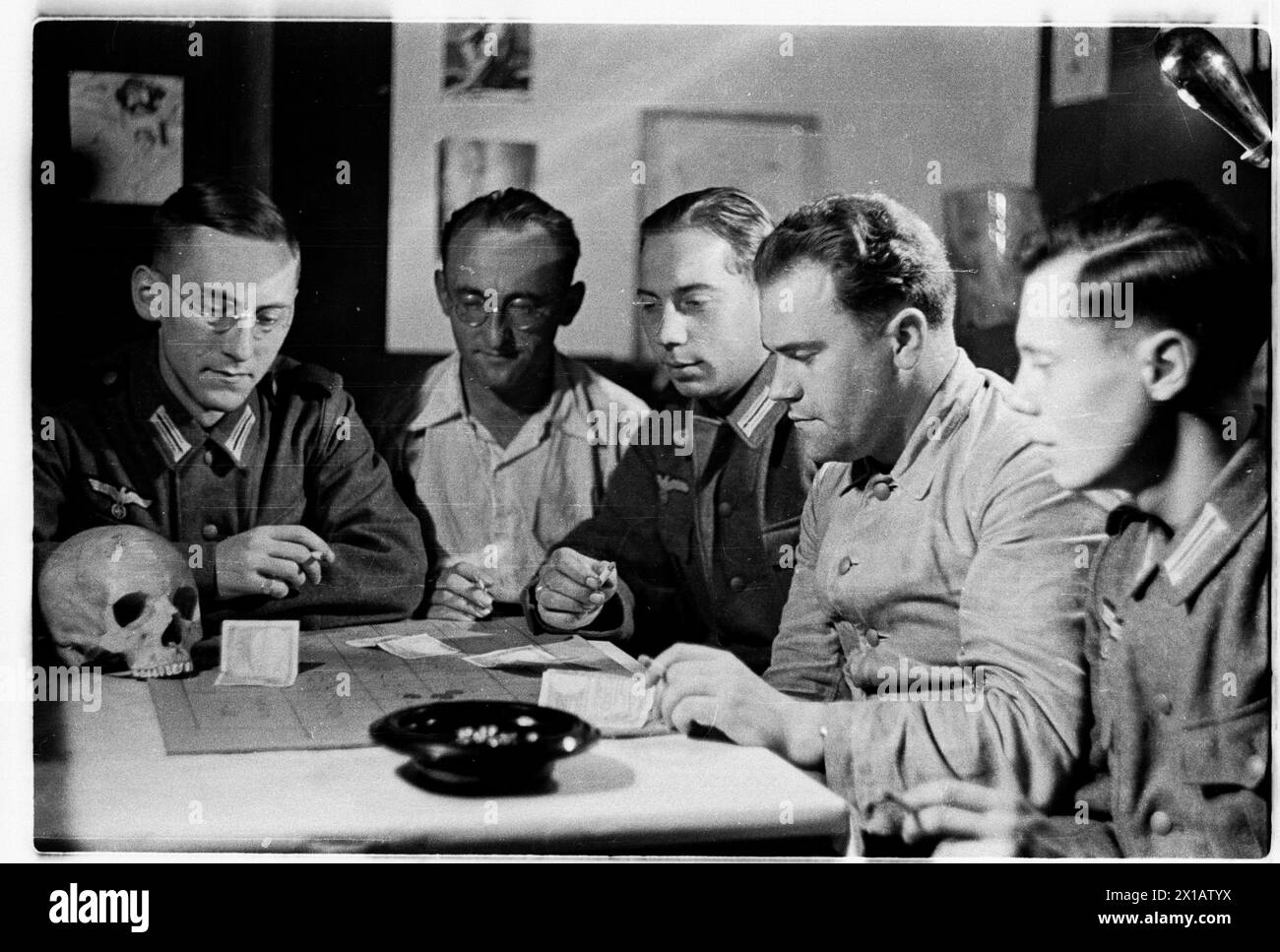 (Numero) cinque membri della Wehrmacht nel laboratorio di chimica dell'ex collegio dei gesuiti, membri dell'assemblea dei predicati di Heydecker spirito affine HEWEHOKIMA, così chiamato dopo la lettera iniziale dei nomi dei membri: He (Heydecker), WE (Wecke), HO (Hocke), KI (Vikar Kirsch) ma (Maecker) durante la partita della Roulette, con teschio e ossa incrociate, 1940 - 19400101 PD3496 - Rechteinfo: Rights Managed (RM) Foto Stock