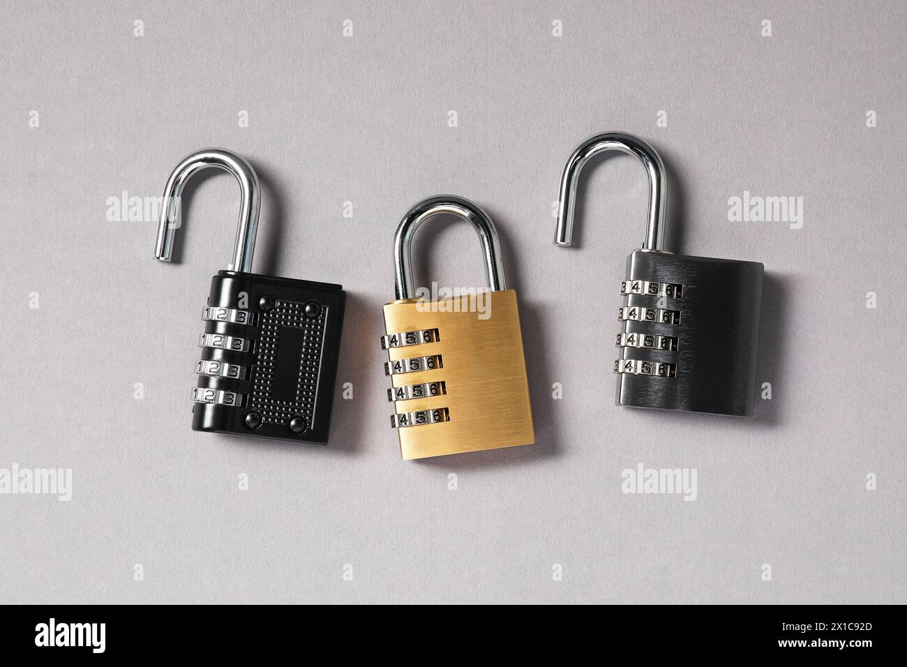 Lucchetti combinati in acciaio su sfondo grigio, vista dall'alto Foto Stock