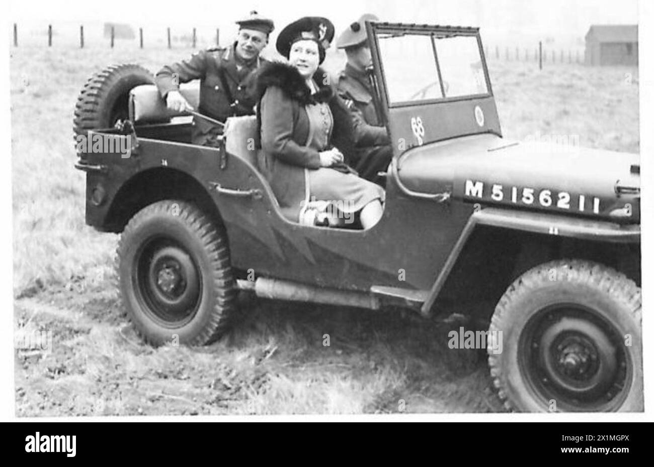 Sua Maestà osserva una dimostrazione militare da una Jeep, che illustra l'impegno reale con operazioni ed esercitazioni dell'esercito. Foto Stock