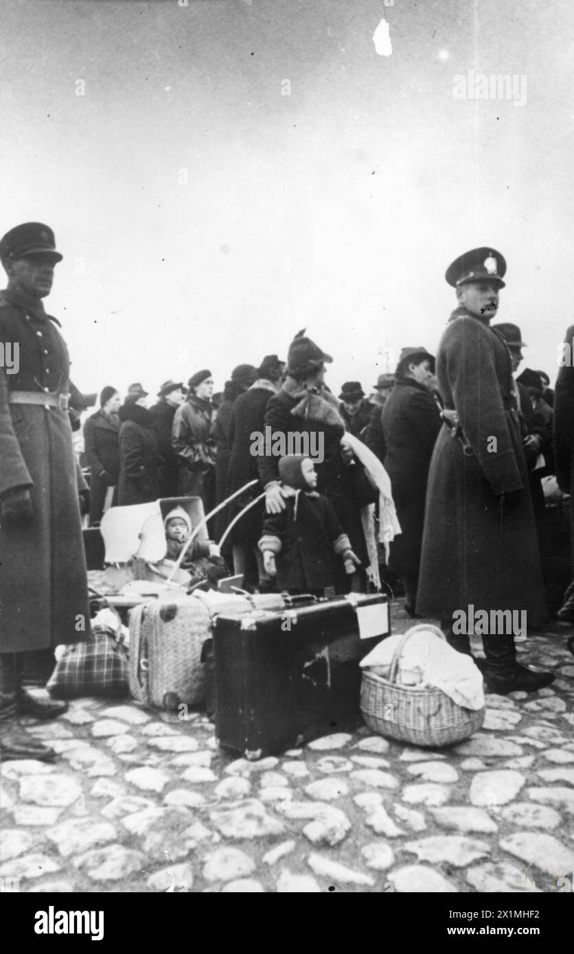 IL REINSEDIAMENTO DI CITTADINI TEDESCHI DEGLI STATI BALTICI NELLA PARTE TEDESCA DELLA POLONIA OCCUPATA, 1940 - cittadini tedeschi della Lettonia in attesa sulla banchina di riga di imbarcarsi su una nave tedesca per portarli nel corridoio polacco, probabilmente 1940.tedeschi degli stati baltici, occupati dai sovietici, furono evacuati nei territori annessi tedeschi della Polonia secondo un accordo tra entrambi i paesi (Germania e Unione Sovietica), l'esercito tedesco Foto Stock