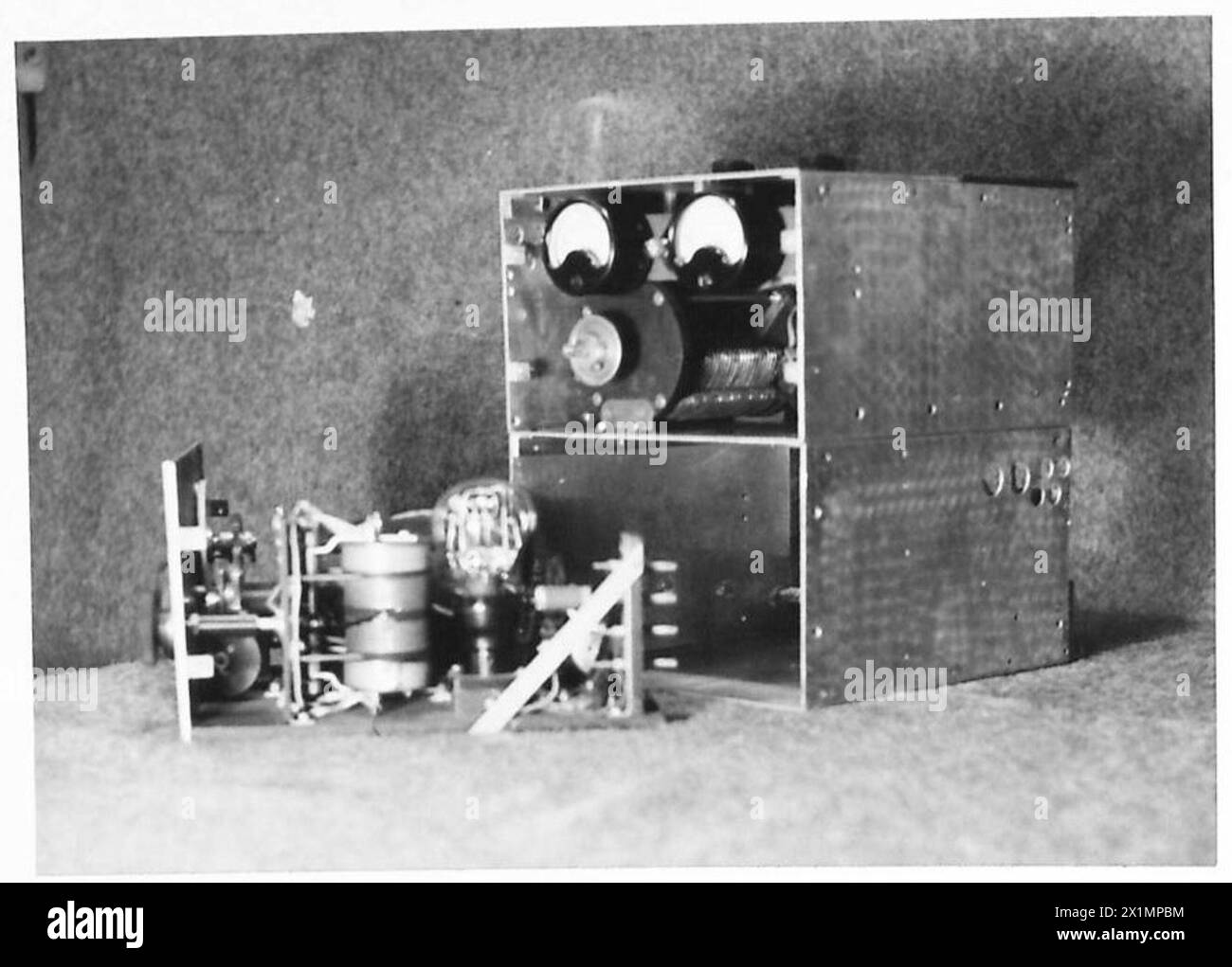 Il pannello anteriore di un set di trasmissione wireless viene rimosso per dimostrare il metodo di sostituzione delle valvole, British Army. Foto Stock