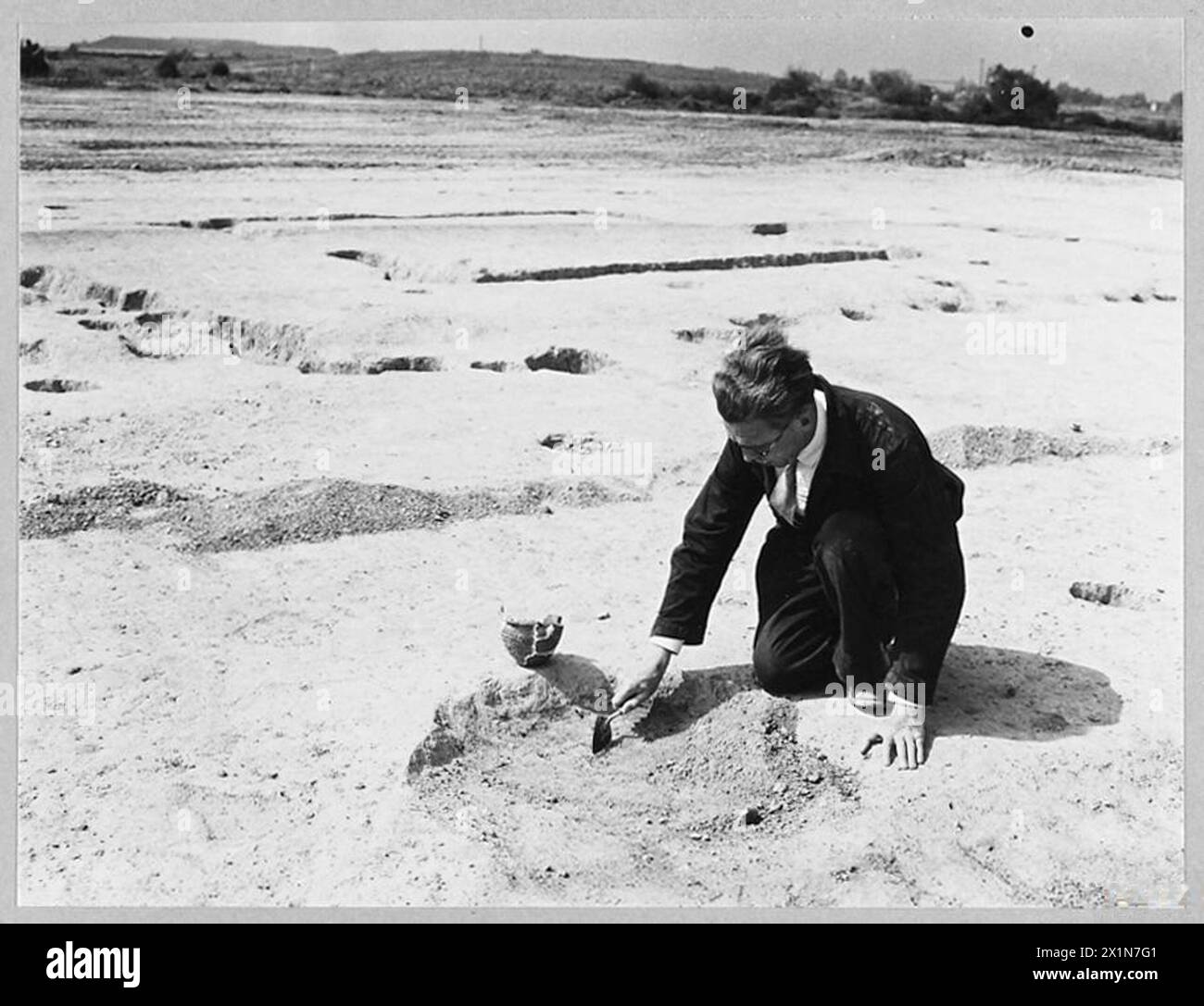 L'archeologo Grimes scava un sito pre-romano in un campo di aviazione della RAF di recente costruzione, scoprendo frammenti di ceramica dell'età della pietra nel 1944. Foto Stock
