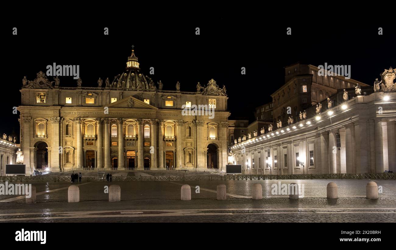 Vista notturna della Basilica di San Pietro nella città del Vaticano, l'enclave papale di Roma, che mette in risalto la sua maestosa sagoma contro il cielo oscurato Foto Stock