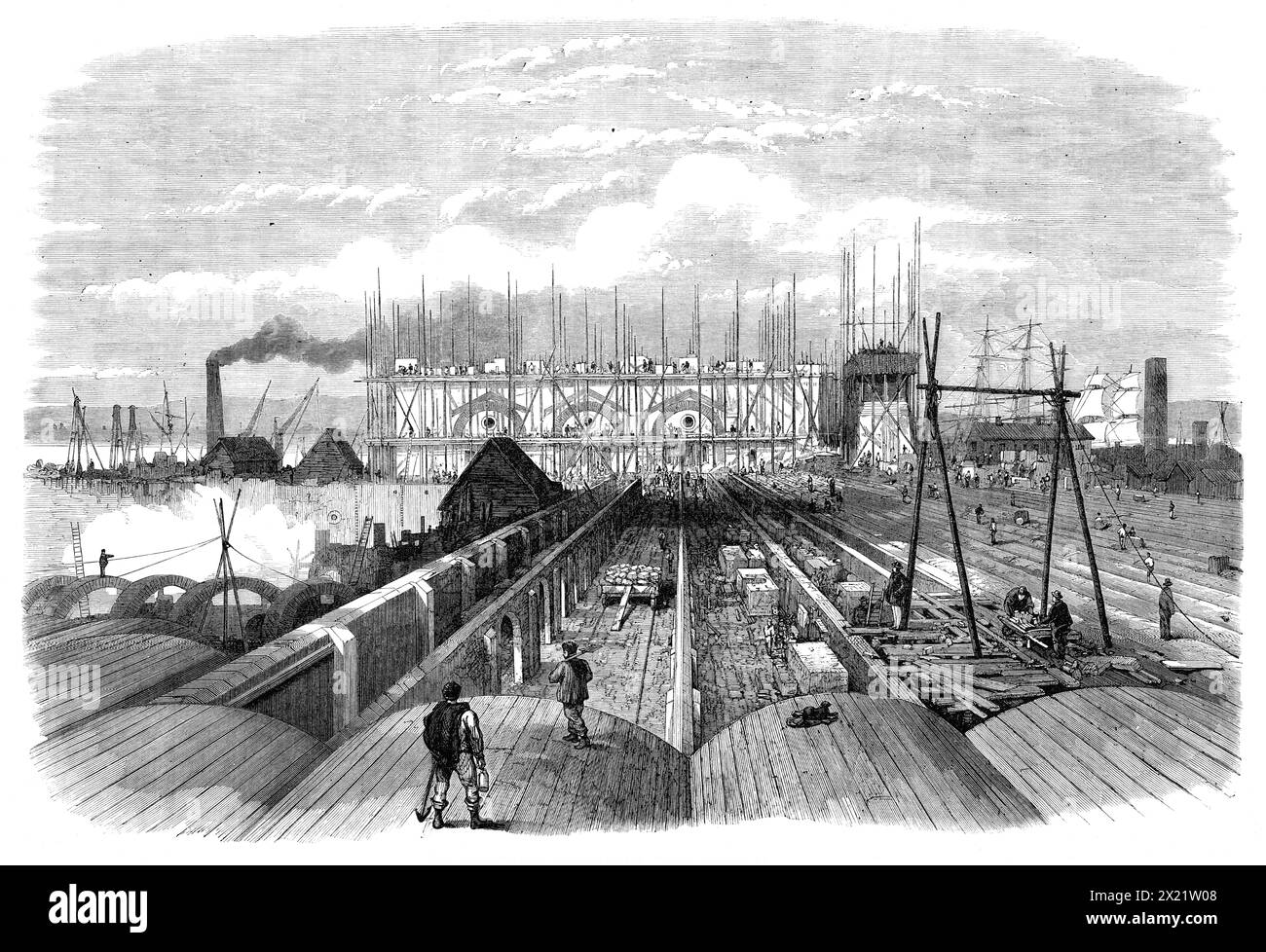 The Metropolitan Main-Drainage Works at Crossness, [Bexley], 1864. Vista di '...i lavori in questo importante sbocco per l'intera fognatura scaricata dall'area sul lato sud del Tamigi. Il grande edificio nel centro... avrà un bell'aspetto dal fiume. Ha notevoli pretese architettoniche...il blocco di edifici...contiene i motori, le caldaie e altri macchinari collegati al grande impianto di pompaggio...le numerose linee di pareti, alcune ad arco, in primo piano...sono le opere del grande serbatoio, in cui le acque reflue si accumulano durante il Foto Stock