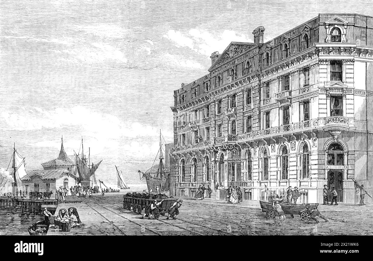 The Great Eastern Railway Terminus and Hotel at Harwich, 1865. "La città e il porto di Harwich... sta diventando una delle stazioni più importanti del nostro commercio con l'Olanda, la Germania e altri paesi del Nord Europa. Il traffico passeggeri, inoltre, della linea dei piroscafi Harwich e Rotterdam, appartenenti alla Great Eastern Railway, è probabilmente non meno significativo. Vi daremo un'illustrazione della nobile pila di edifici che la Great Eastern Railway Company ha eretto, vicino al porto e al molo dei battelli a vapore... lo stile dell'architettura è italiano... la facciata è molto bella. IO Foto Stock