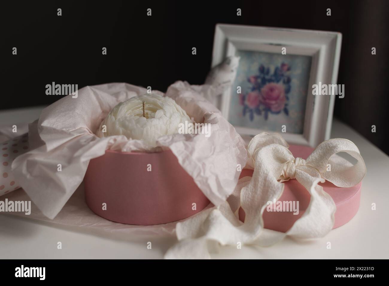 candela fatta a mano a forma di fiore in una confezione regalo. Foto di alta qualità Foto Stock