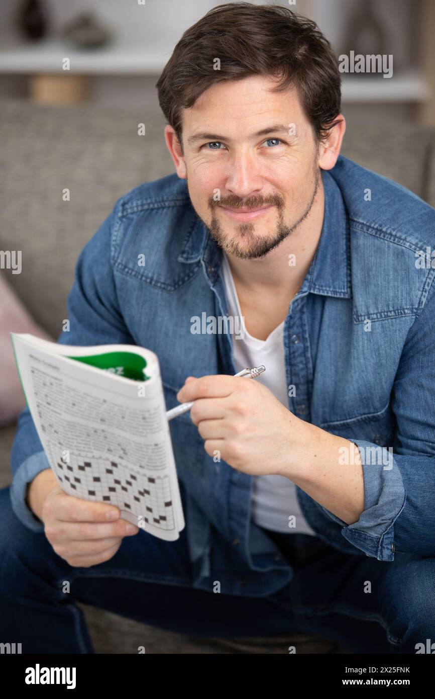 un uomo sorridente sul divano Foto Stock