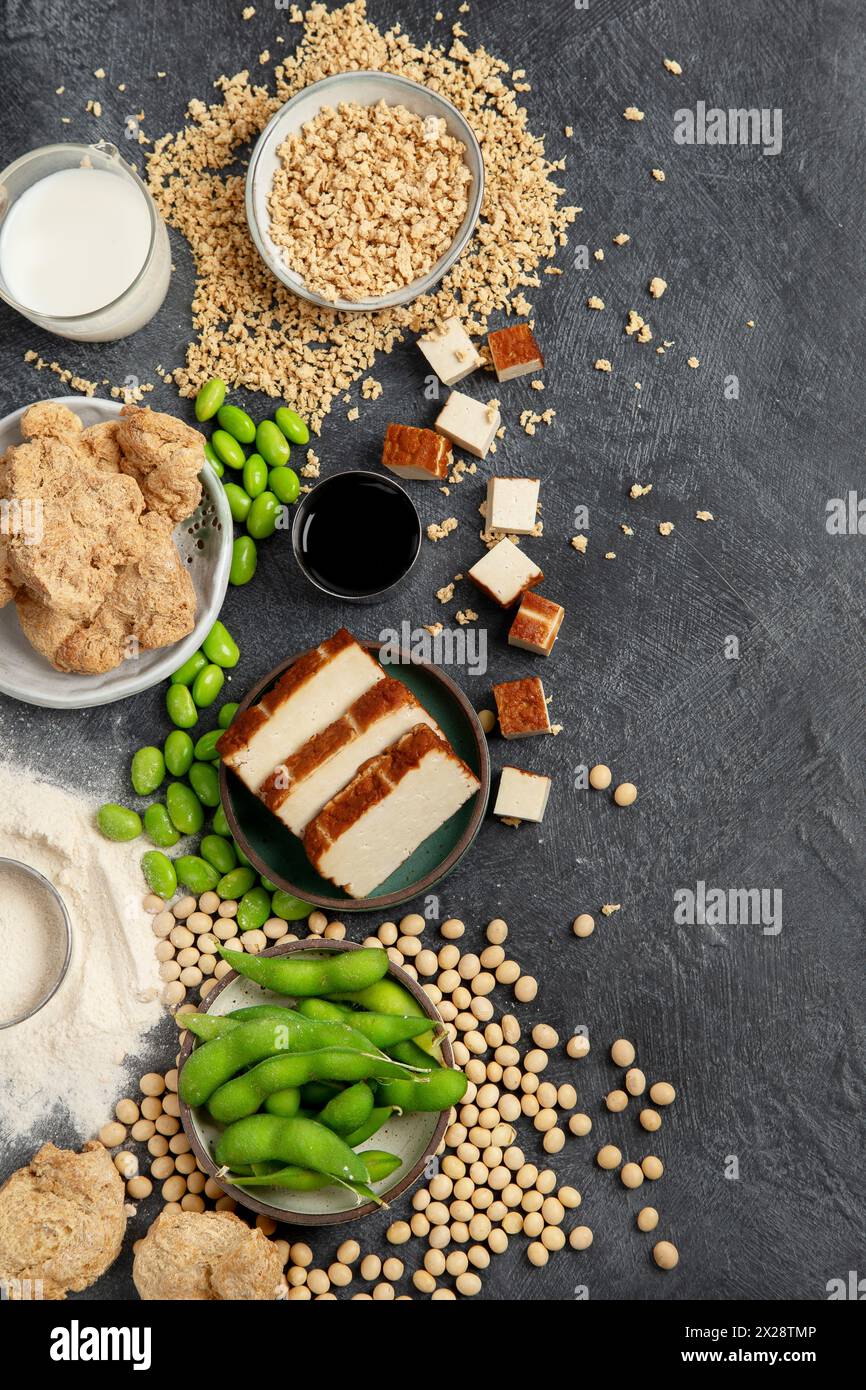 Prodotti di soia su sfondo nero. Cibo sano vegano. Vista dall'alto, copia spazio Foto Stock