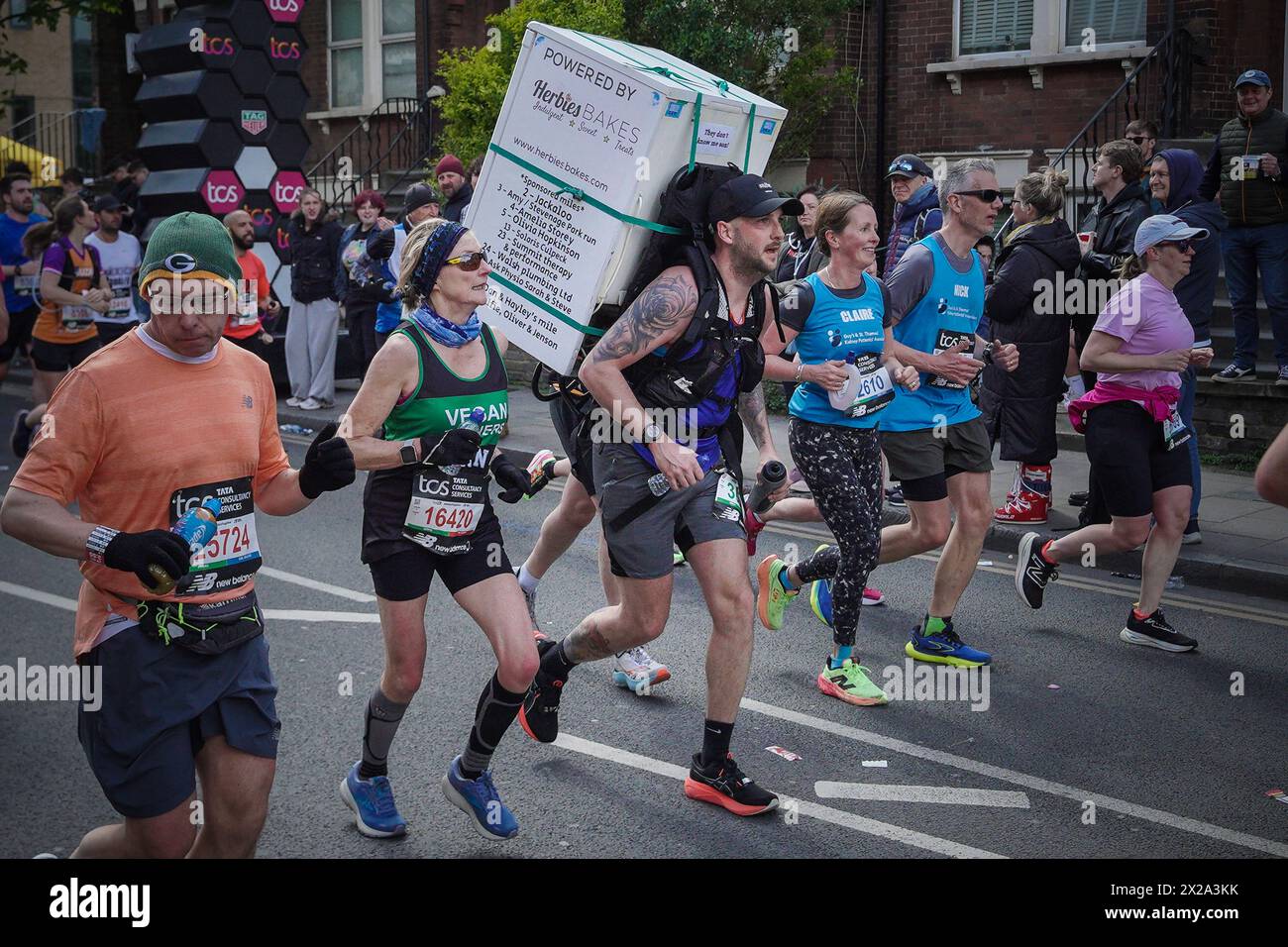 Londra, Regno Unito. 21 aprile 2024. Viene portato un frigo. La maratona di Londra passa lungo Evelyn Street di Deptford nel sud-est di Londra, il percorso di 26,2 miglia, dove i corridori vengono accolti e applauditi dai residenti locali. Crediti: Guy Corbishley/Alamy Live News Foto Stock