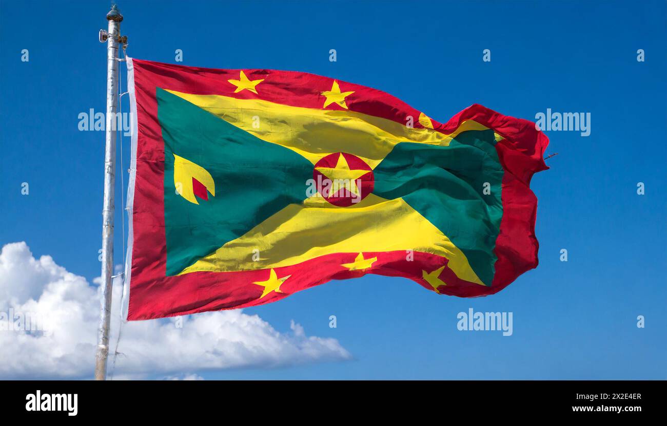 Die Fahne von Grenada, Karibik, Flattert im Wind, isoliert, gegen den blauen Himmel Foto Stock