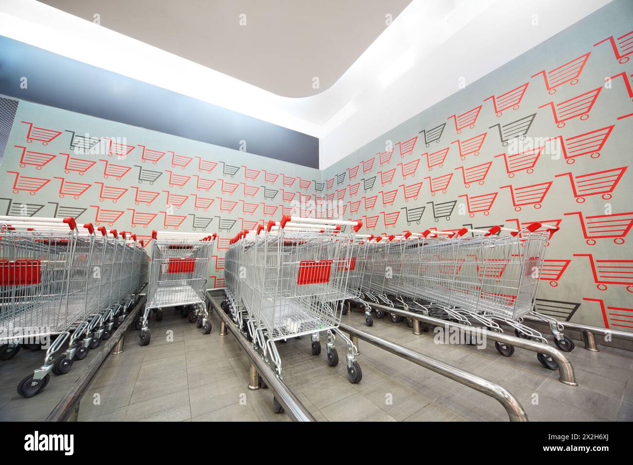 Set di carrelli piegati l'uno nell'altro nel supermercato Foto Stock