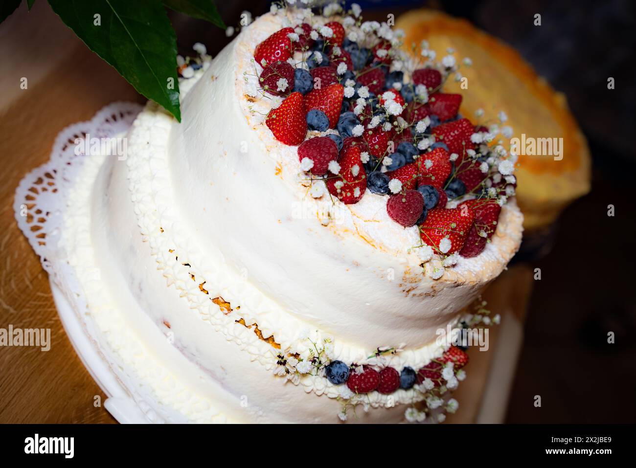 Torta nuziale cremosa con frutti di bosco Foto Stock