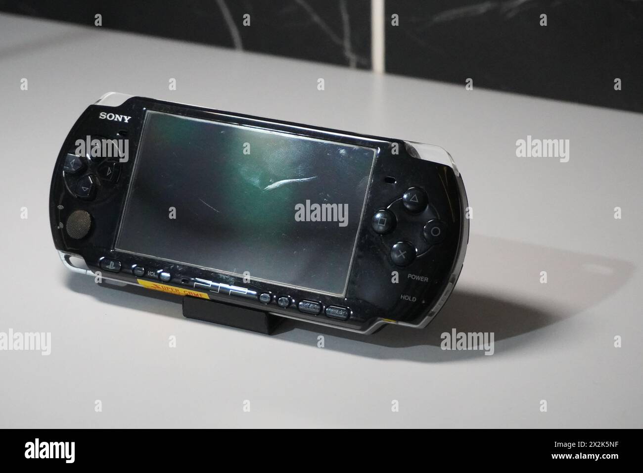 Una console di gioco portatile nera di Sony chiamata PSP su un tavolo bianco Foto Stock