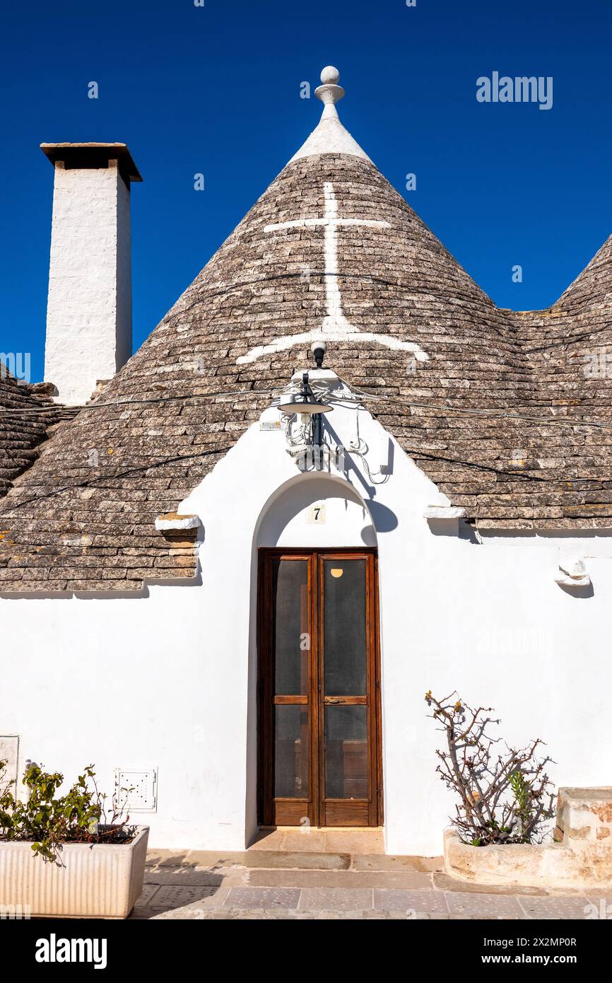 Simboli imbiancati sul tetto in pietra ristrutturato di un Trullo, Alberobello, Italia Foto Stock