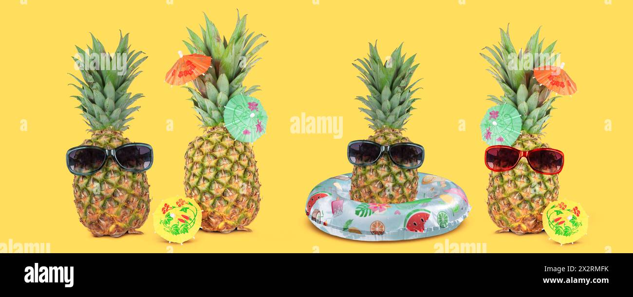 Concetto di vacanza estiva tropicale con ananas divertenti ed eleganti isolati su sfondo giallo. Foto Stock