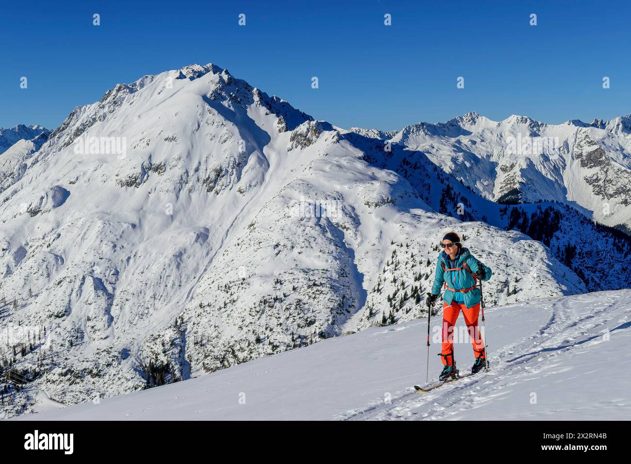 Sci di fondo donna maturo a Gruenstein con le Alpi Lechtal sullo sfondo, Mieming Range, Tirolo, Austria Foto Stock