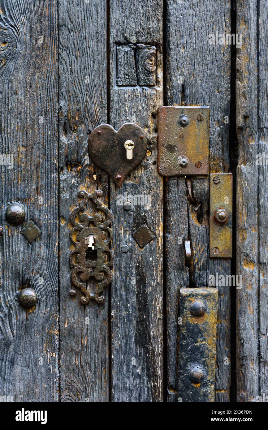 Antica porta in legno di quercia del XVII/XVIII secolo con borchie in ferro e finiture in bronzo - Tours, Indre-et-Loire (37), Francia. Foto Stock