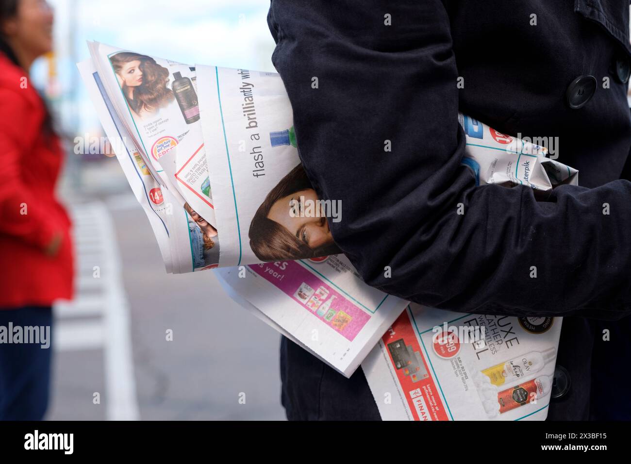 Giornali tenuti da un uomo per strada. Foto Stock