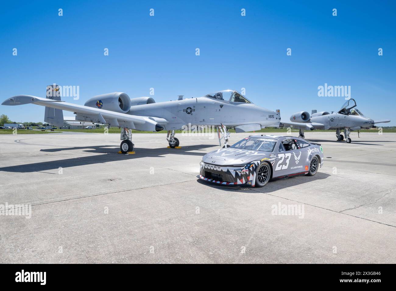 La Würth 400 NASCAR Cup Series No. 23 Toyota Camry siede con due A-10C Thunderbolt IIS della U.S. Air Force sulla linea di volo della dover Air Force base, Delaware, 26 aprile 2024. Bubba Wallace, il pilota della vettura, ha visitato dover AFB prima della gara del fine settimana al dover Motor Speedway. (Foto U.S. Air Force di Mauricio Campino) Foto Stock