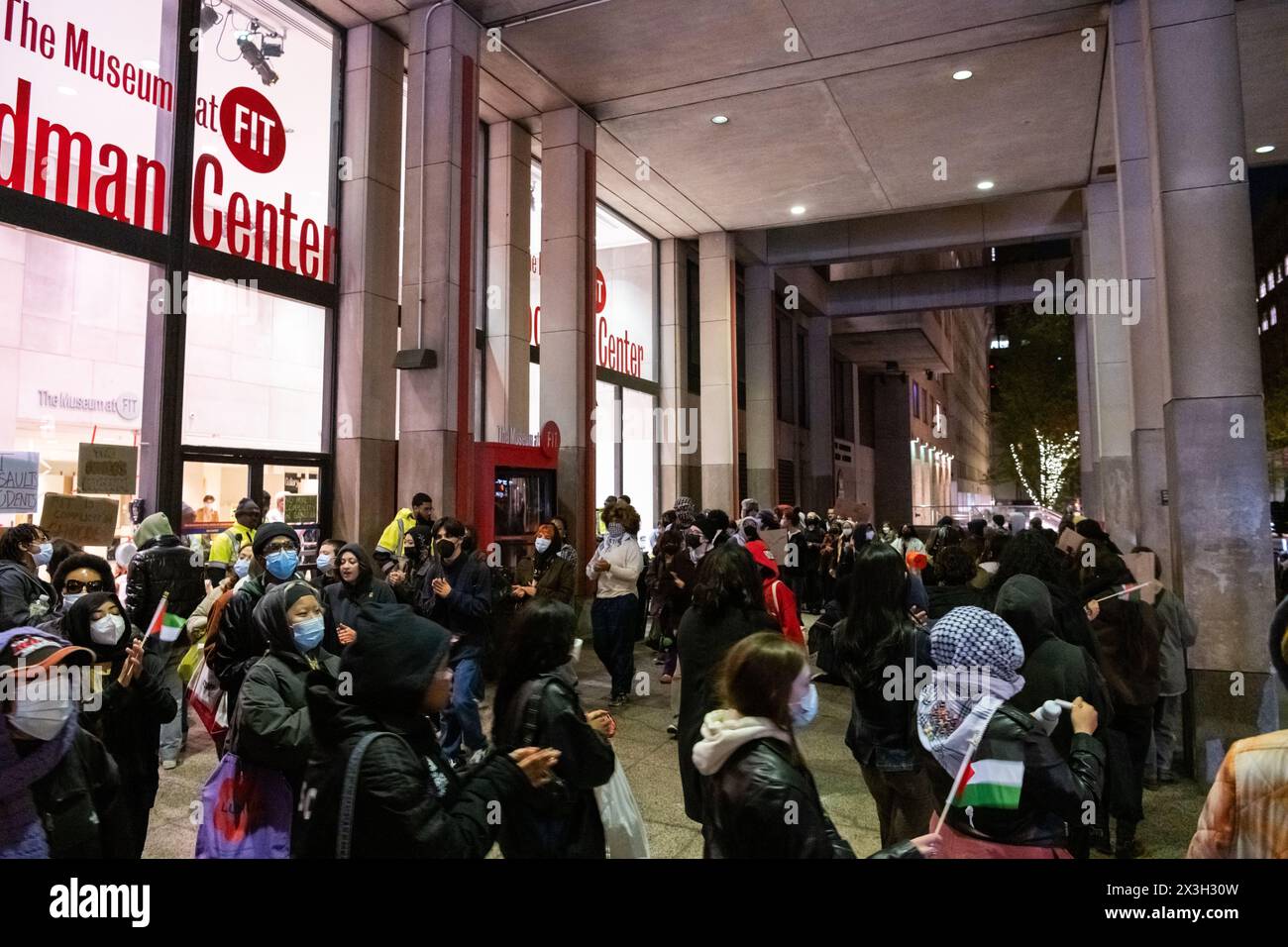 I manifestanti fuori dal museo del Fashion Institute of Technology sostengono l'accampamento degli studenti all'interno del museo protestando per la Palestina. Molti dei manifestanti all'esterno volevano unirsi all'accampamento, ma il museo era chiuso per la sera e la sicurezza non avrebbe permesso l'ingresso di più studenti. Foto Stock