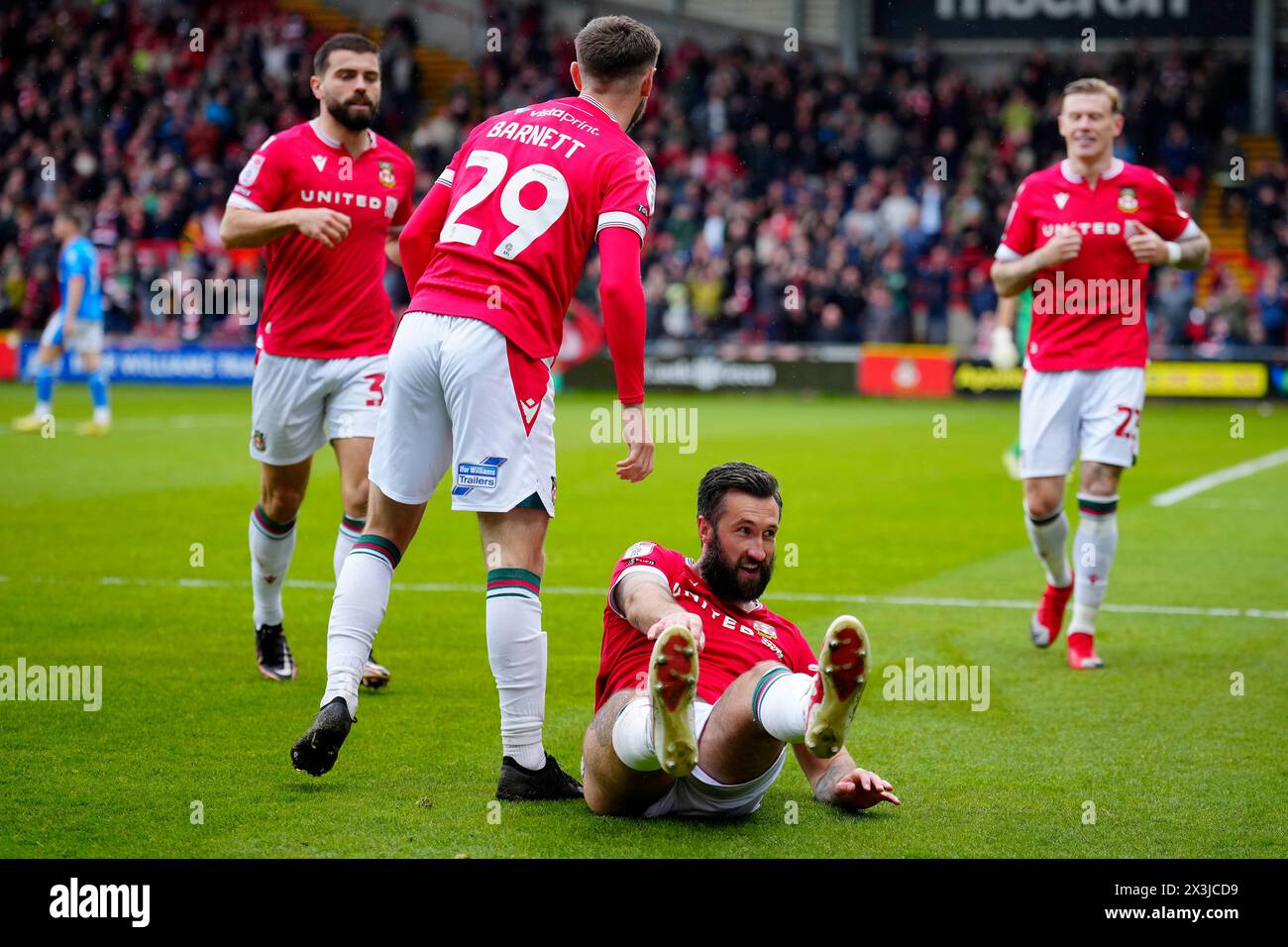 Wrexham players celebrate after scoring their side's first goal during the English League Two soccer match between Wrexham and Stockport at the Racecourse Ground Stadium in Wrexham, Wales, Saturday, April 27, 2024.(AP Photo/Jon Super) Foto Stock
