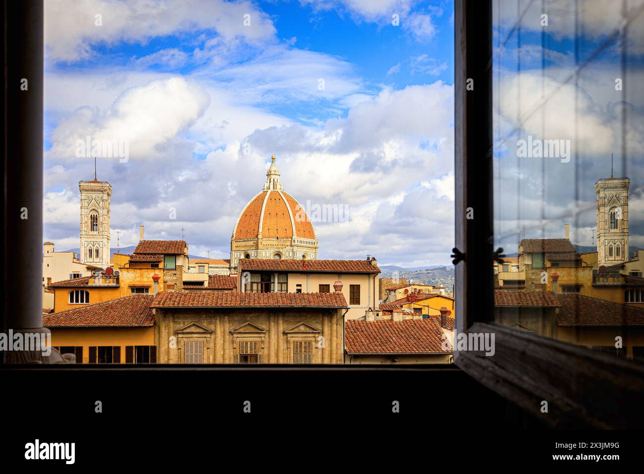 Splendida vista di Firenze con la cupola e la torre di Santa Maria del Fiore da una finestra aperta. Foto scattata il 21 ottobre 2023 a Firenze, Tusca Foto Stock