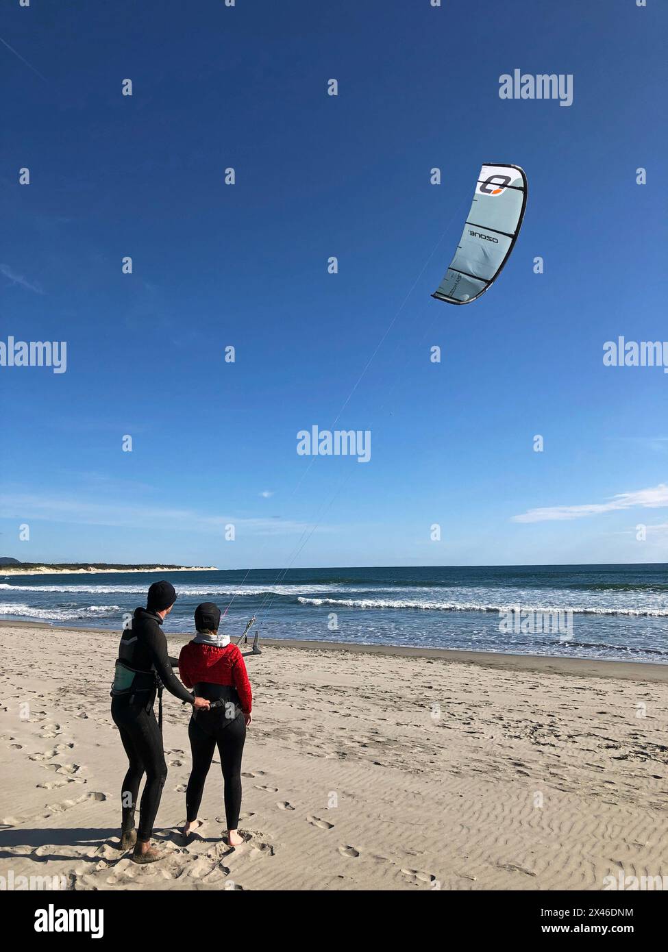 Cabedelo, Viana do Castelo, Portogallo - 29 aprile 2024: Un istruttore di kite-surf guida un apprendista attraverso la pratica di controllo degli aquiloni a Cabedelo Beach, Por Foto Stock