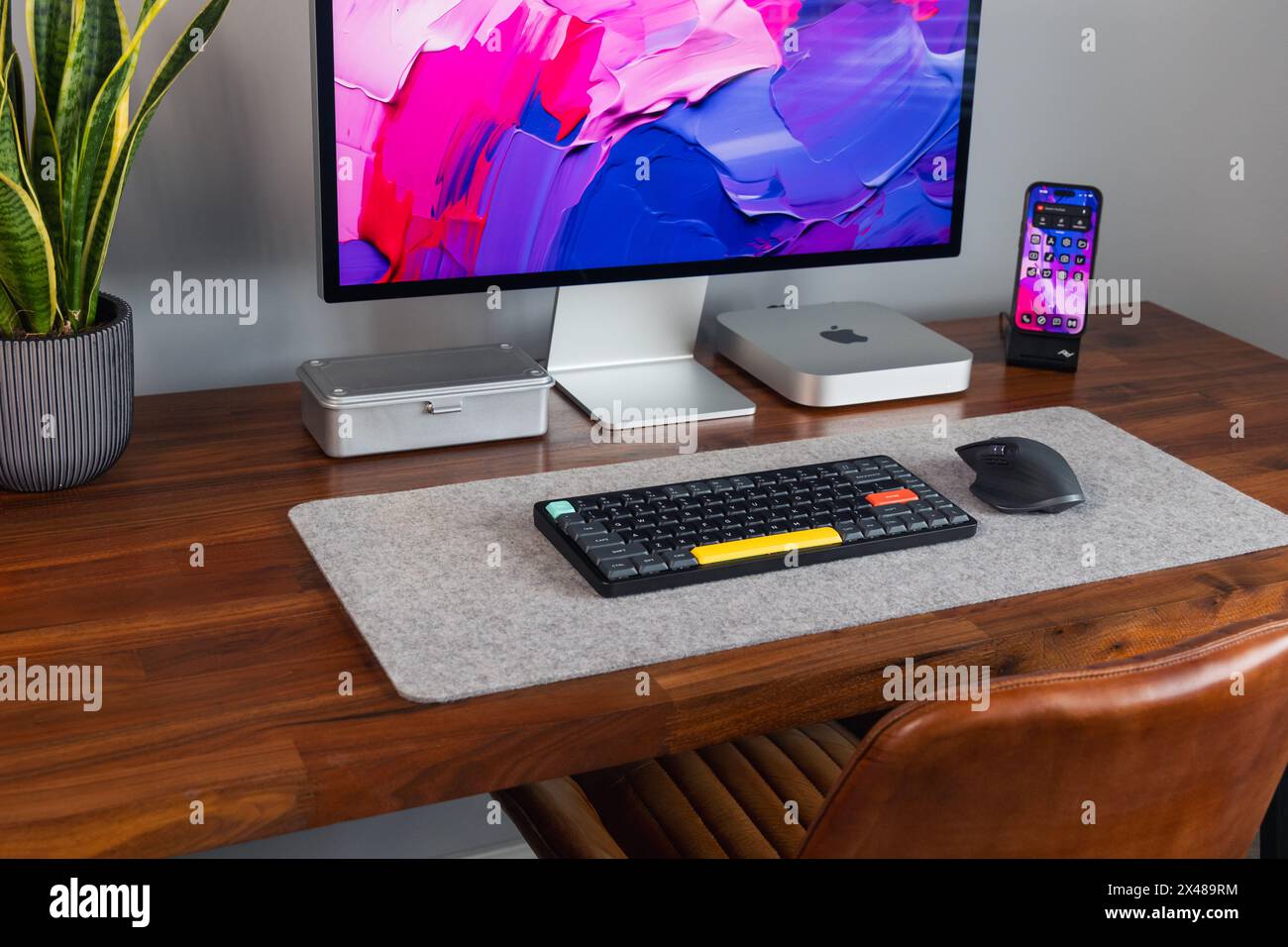 LONDRA - 30 APRILE 2024: Computer Apple Mac in un moderno ufficio domestico, lavoro da casa configurazione minima della scrivania Foto Stock