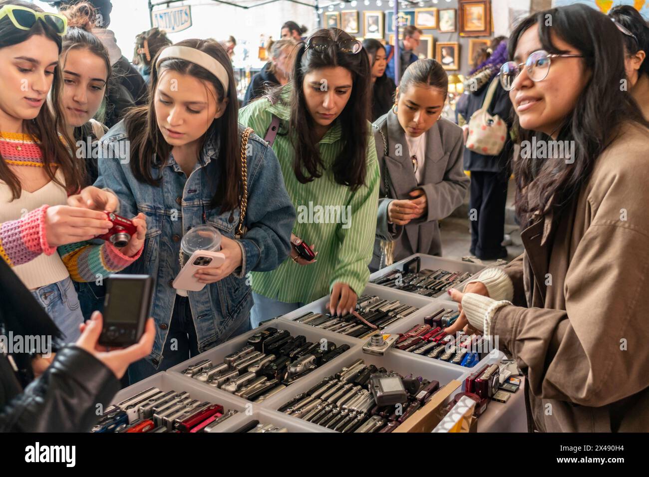 Le donne della Gen Z acquistano fotocamere digitali più vecchie in un mercato delle pulci nel quartiere di Dumbo a Brooklyn, New York, sabato 27 aprile 2024. (© Richard B. Levine) Foto Stock