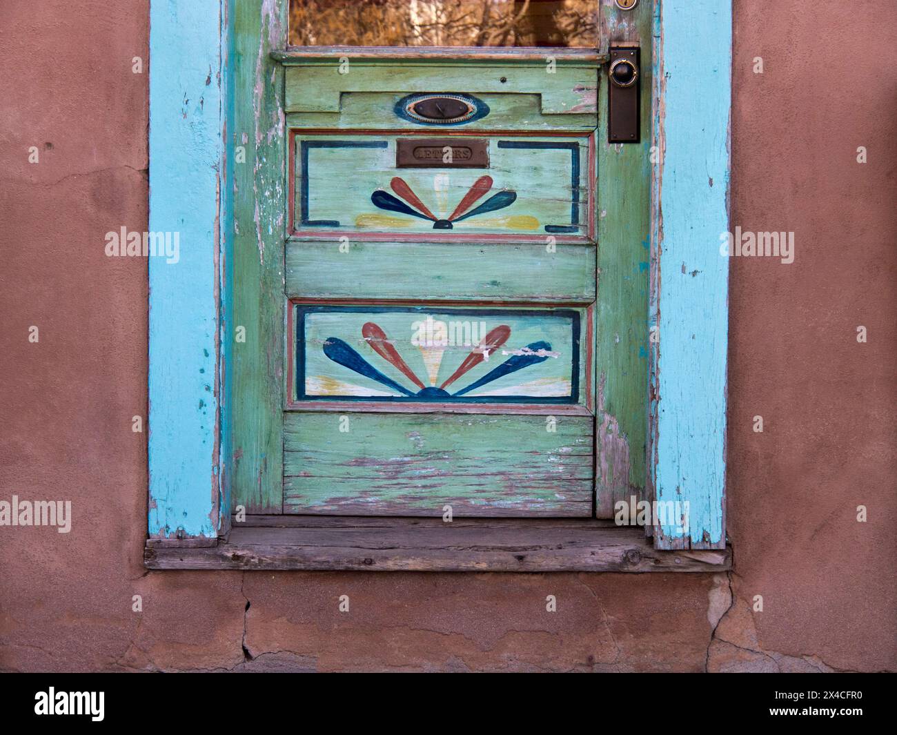 Stati Uniti, nuovo Messico, Sante Fe. Sezione inferiore di una porta di legno colorata con opere d'arte dipinte a mano. Foto Stock