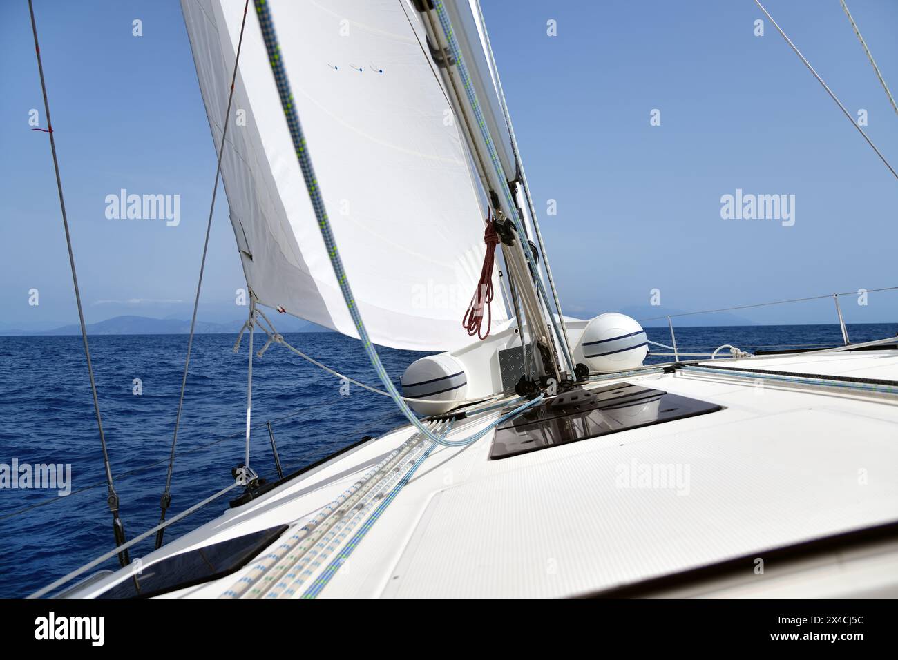 Crociera in barca a vela in Turchia. Splendido yacht bianco che regala veloci in mare in una giornata di sole. Vista dal ponte dello yacht, montagne sullo sfondo Foto Stock