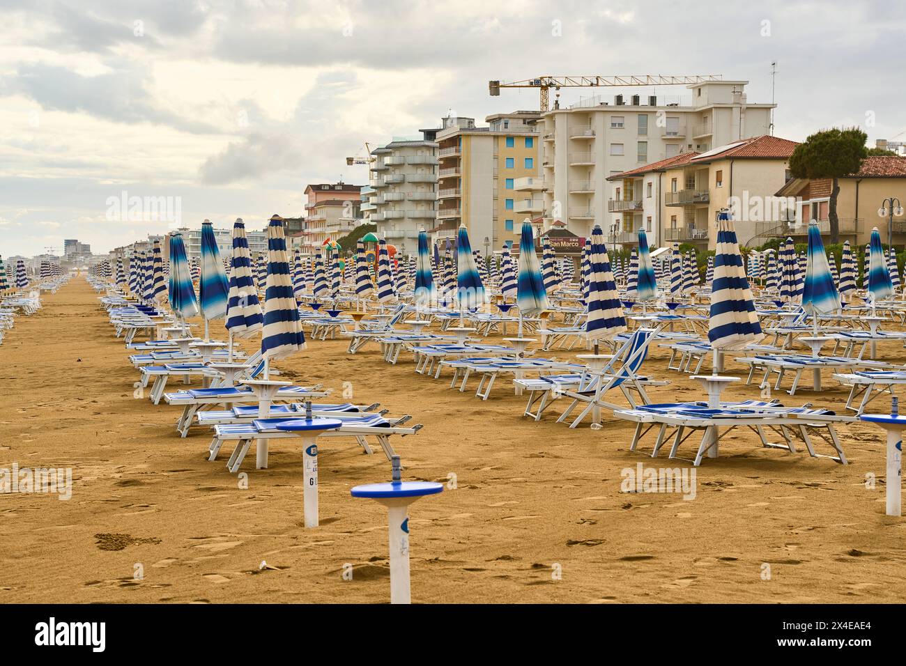 Lido di Jesolo, Italia - 2 maggio 2024: Ombrelloni chiusi sulla spiaggia di Lido di Jesolo in Italia *** Geschlossene Sonnenschirme am Strand von Lido di Jesolo in Italia Foto Stock