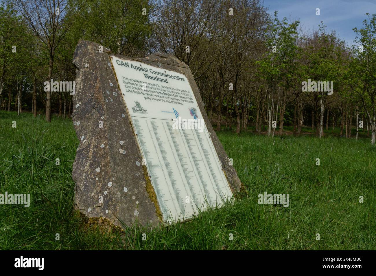 Una targa di pietra in un Memorial Wood a St Ives Estate, Bingley. I nomi di coloro che hanno fatto piantare un albero in loro memoria sono elencati sulla targa. Foto Stock