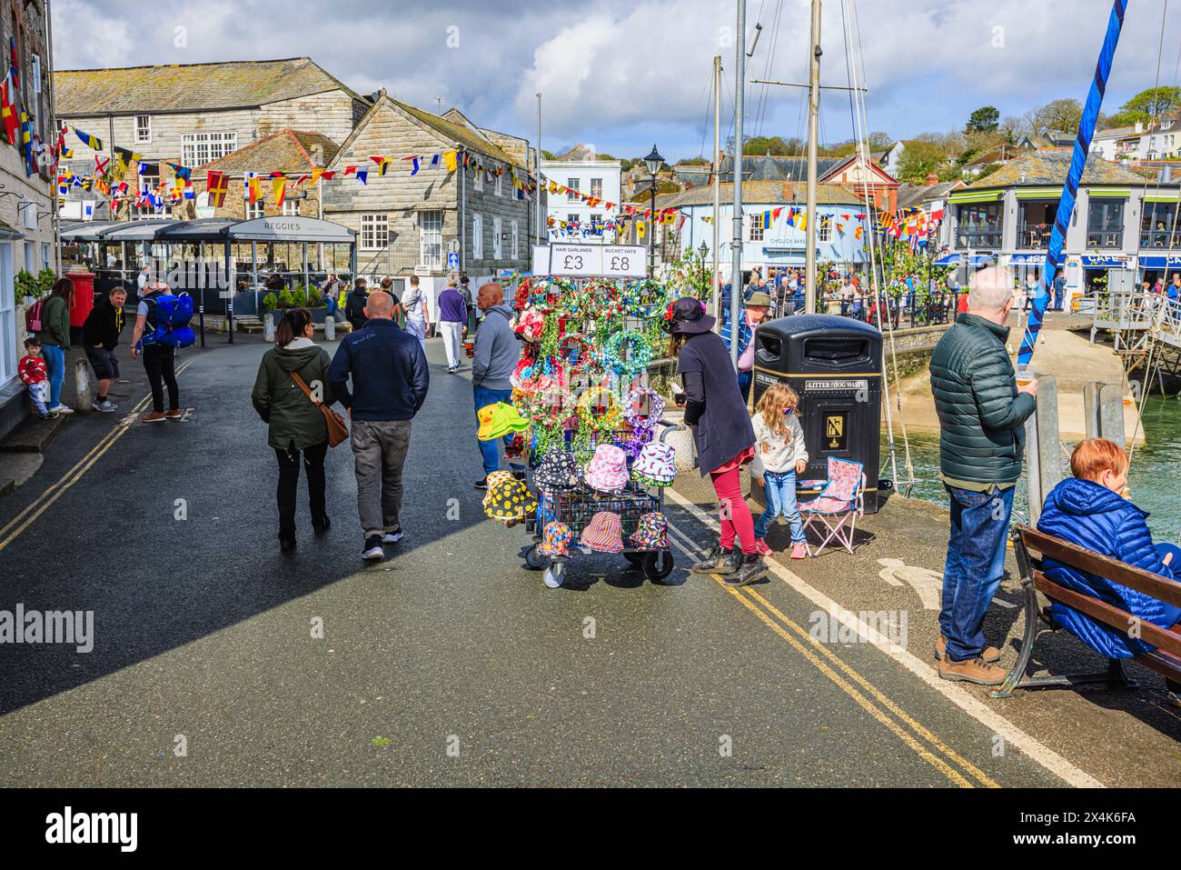 Ghirlande e cappelli in vendita presso il porto per il festival 'Obby' Oss, un evento popolare annuale del May Day a Padstow, una città costiera nella Cornovaglia settentrionale Foto Stock