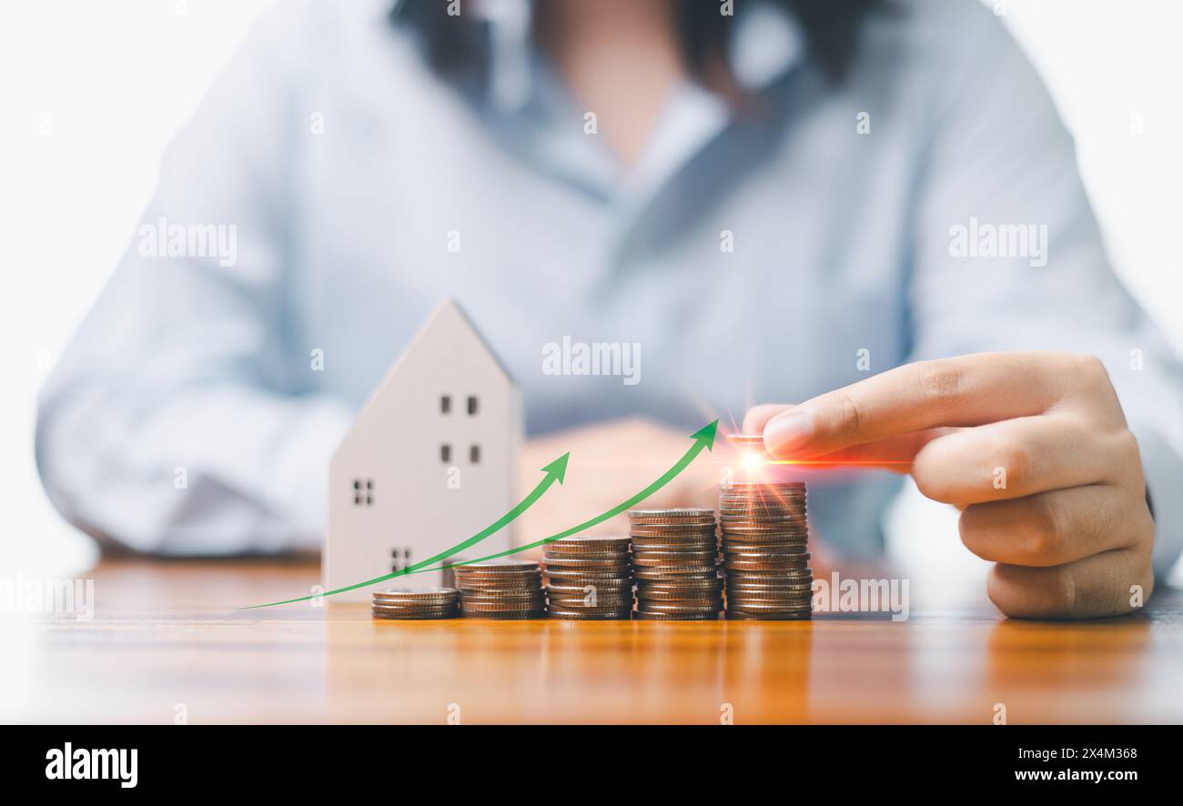 L'investimento nel settore immobiliare è un concetto chiave nel mondo della finanza e delle imprese, in cui la garanzia di un mutuo consente ai privati di possedere una casa come parte di un'azienda Foto Stock