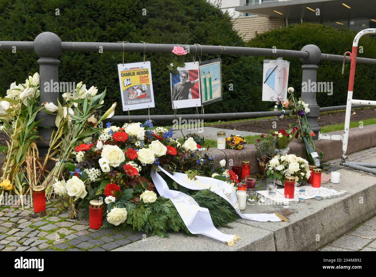 Wegen einer tödlichen Messerattake a Nizza werden Blumen vor der französischen Botschaft am Pariser Platz abgelegt. Dazu hängen einzelne kleine Plakate, wie eins über Charlie Hebdo. A Nizza hatte AM 29. Oktober gegen 9,00 Uhr ein islamistischer Attentäter in der Kirche Notre-Dame eine Messerattacke verübt. Dabei tötet er zwei Frauen, dazu einen Mann, der in eine nahe gelegene Bar flüchtet und dort stirbt. Der Täter rief Allahu akbar Gott ist Groß. Mehrere Menschen werden bei dem Angriff verletzt, bis der mutmaßliche Täter festgenommen werden kann. Dazu wurde 16. Oktober a Conflans-Sainte Foto Stock