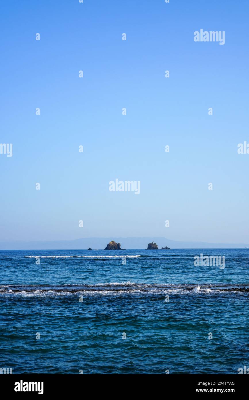 Spiaggia con una grande roccia al centro che è nascosta e deserta dai turisti Foto Stock
