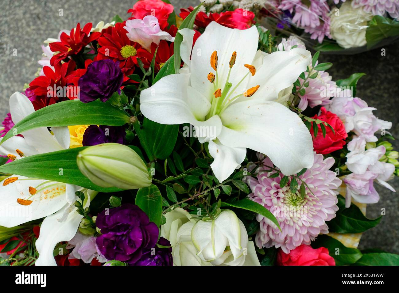 Colorata composizione floreale con giglio bianco (Lilium candidum) e accenti viola, vendita fiori, stazione centrale, Amburgo, città anseatica di Amburgo Foto Stock