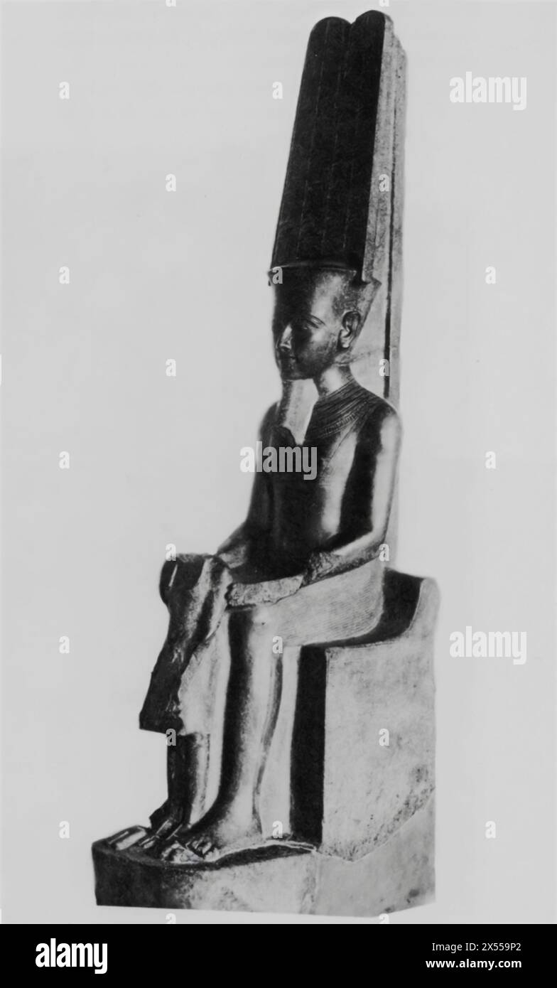 Scultura di granito del Dio Amon che protegge il re Tutankhamon, datata intorno al 1200 a.C., XVIII dinastia, ospitata al Museo del Louvre, Parigi, Francia. Questa scultura seduto cattura Amon, il re degli dei, che protegge il re Tutankhamon. Questo pezzo ha segni di mutilazione, che si crede sia opera del suo successore, Horemheb, che mirava a cancellare l'eredità di Tutankhamon e a distruggere la sua protezione divina. Foto Stock