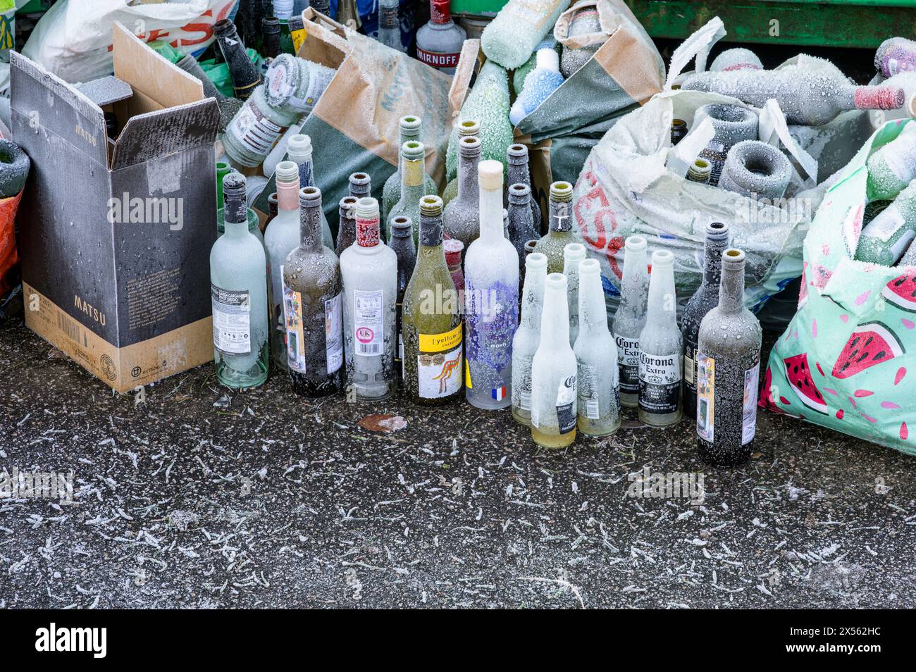 Bottiglie di vino in vetro congelato in attesa di essere raccolte in un'area di riciclaggio comune in inverno, Glasgow, Scozia, Regno Unito, Europa Foto Stock