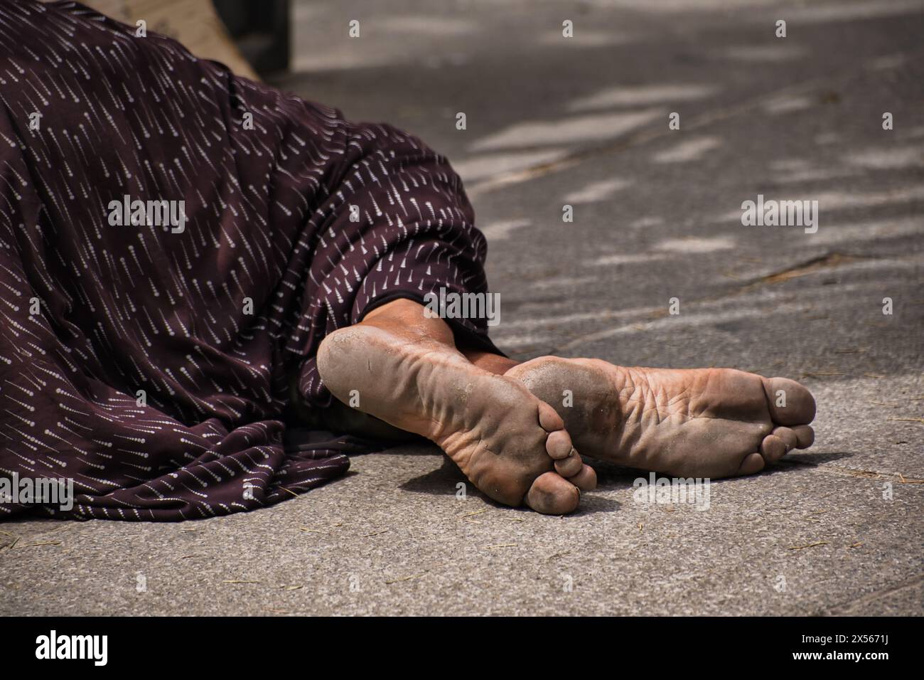 Primo piano dei piedi di una donna che implorava fuori da una chiesa a Madrid Foto Stock