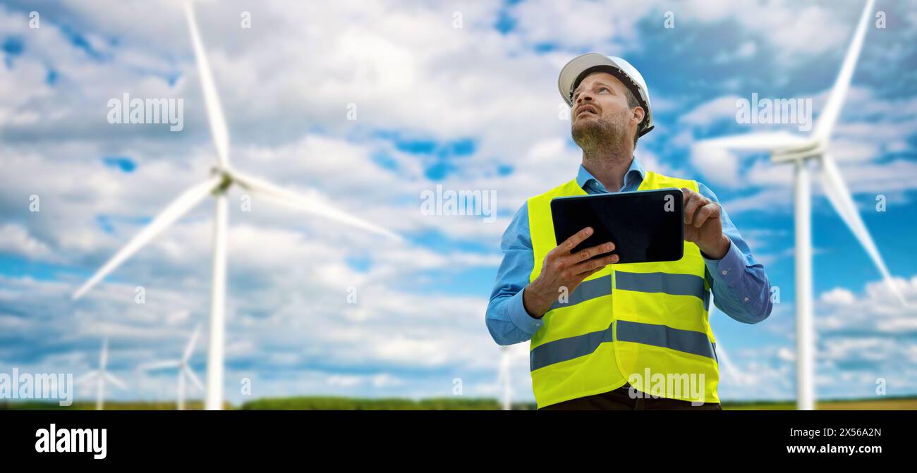 ingegnere con tablet digitale che lavora al parco delle turbine eoliche. produzione di energia sostenibile. spazio di copia banner Foto Stock