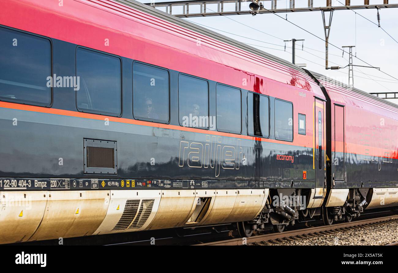 Der ÖBB Railjet ist aus Wien unterwegs an den Hauptbahnhof Zürich. Gezogen wird der Personenzug von einer Taurus Lokomotive. Der Zug fährt beim Bahnho Foto Stock