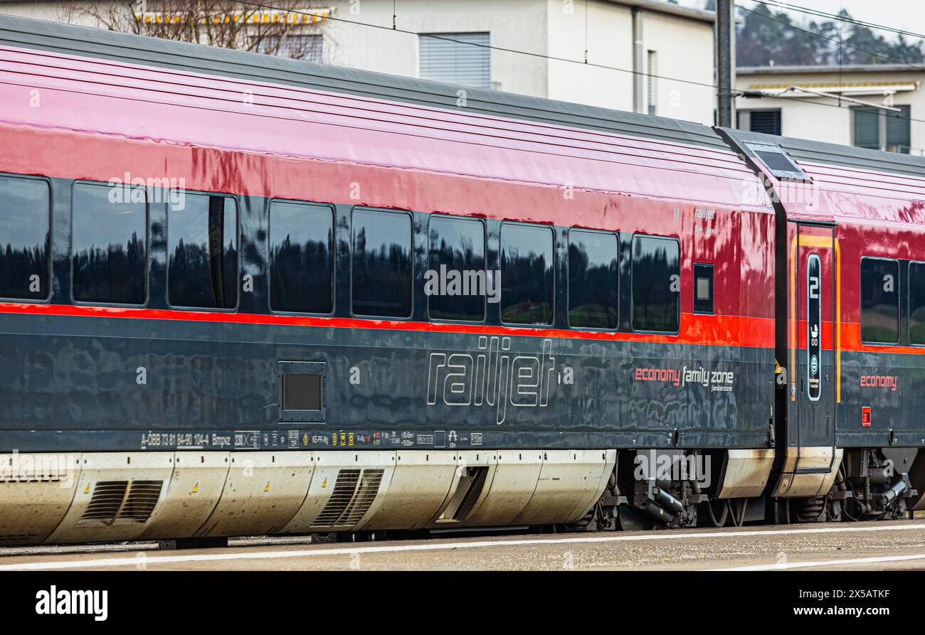 Der ÖBB Railjet ist aus Wien unterwegs an den Hauptbahnhof Zürich. Gezogen wird der Personenzug von einer Taurus Lokomotive. Der Zug fährt beim Bahnho Foto Stock